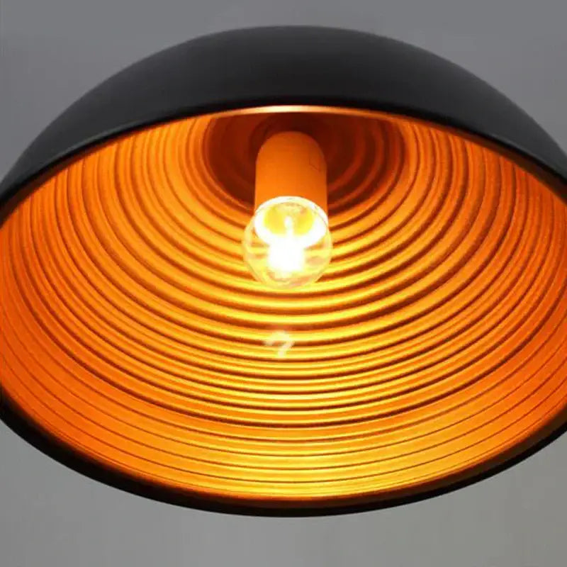Retro black and gold semicircle pendant light with a black pot cover and orange ribbed interior for dining room decorbites pendant light