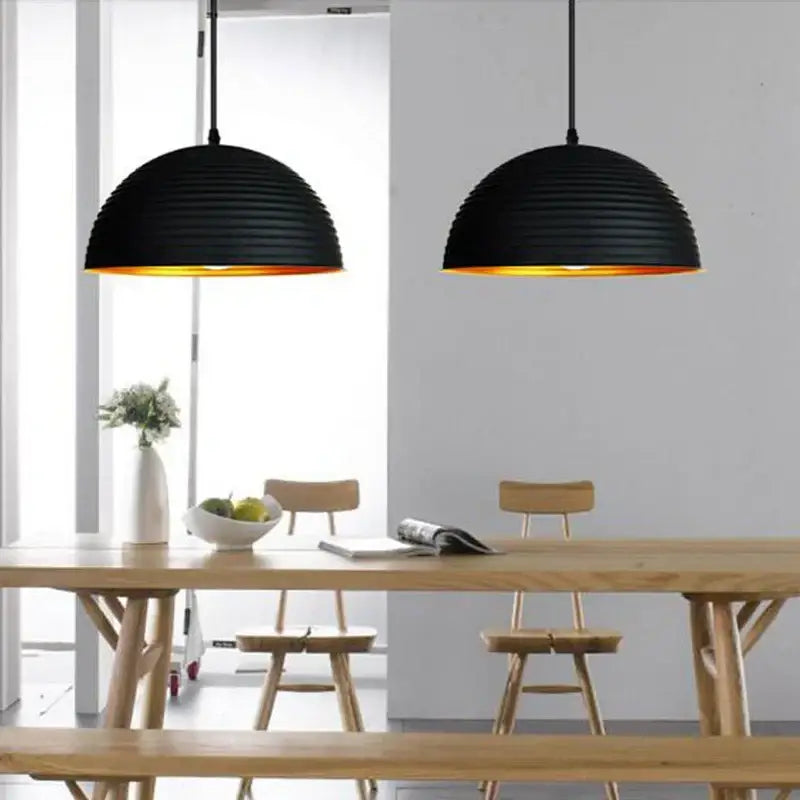 Retro black and gold semicircle pendant light with ribbed black pot cover and warm gold interior for dining room decorbites pendant light