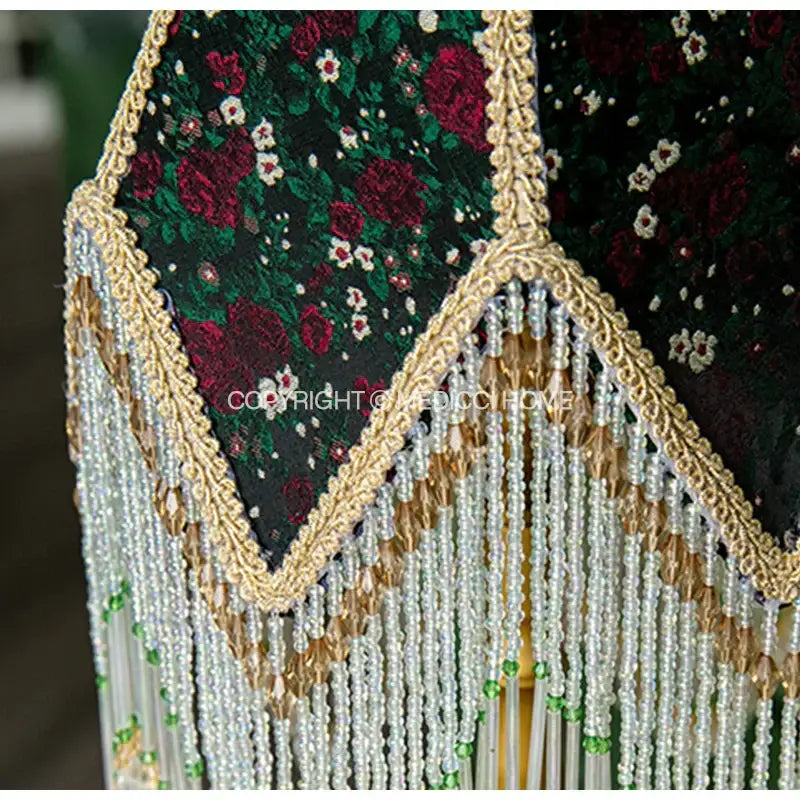 A luxurious dark green velvet roses retro table lamp with embroidered roses and gold lace beaded fringe shade