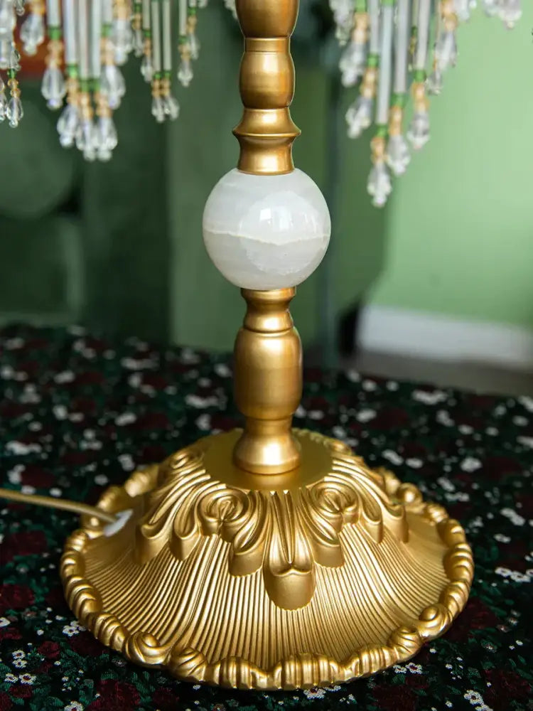 Golden ornate base retro table lamp with polished white onyx sphere and intricate leaf detailing for roses retro table