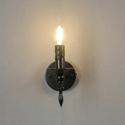 Retro black iron art wall lamp with candle-style wrought iron sconce and glowing filament bulb for living room decorbites iron art wall