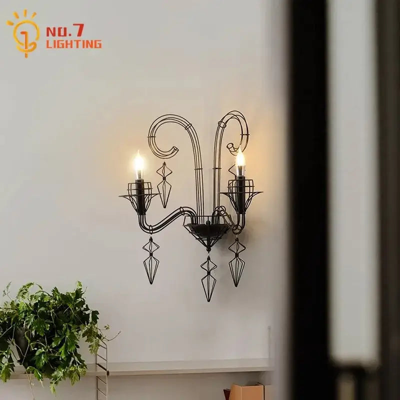 Retro black wrought iron wall lamp with ornate curved arms and geometric crystal accents for candle wall use