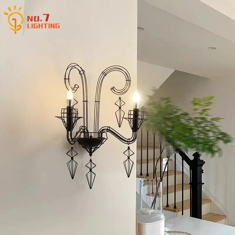 Retro black iron candle wall lamp with ornate scrollwork and geometric crystal accents for living room wall lamp