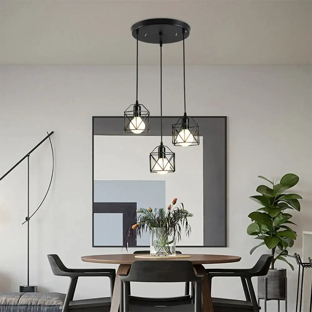 Black geometric iron frame pendant light with modern industrial design hanging above dining table by decorbites iron frame