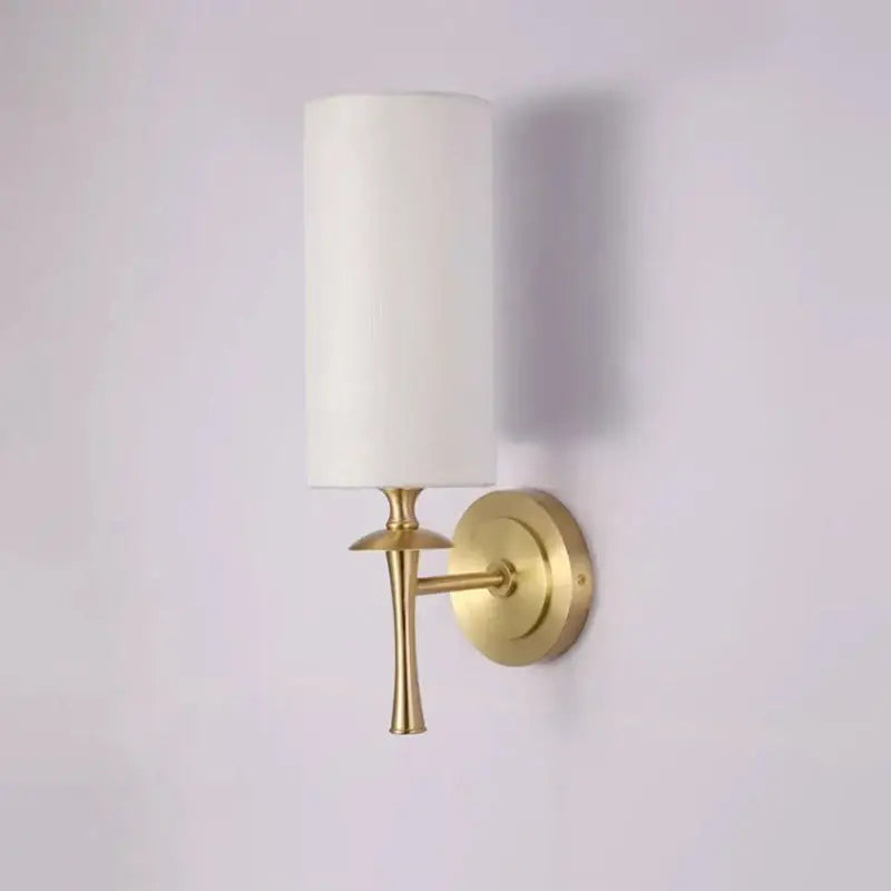 A sleek retro black metal brass wall lamp with a cylindrical white fabric shade for bedroom decorbites brass wall lamp