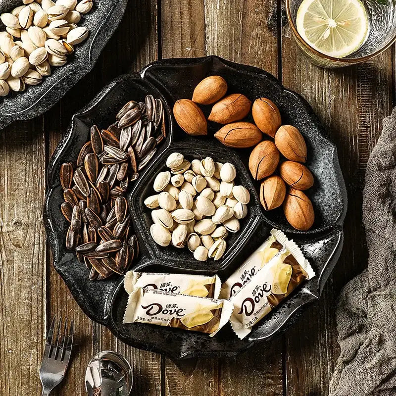 Black decorbites ceramic 4-grid dinner plate serving platter with floral edge holding sunflower seeds pistachios almonds