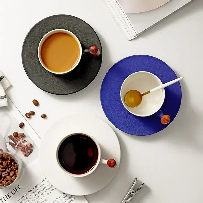 Three ceramic coffee cups with wooden handles in black blue and white on matching saucers for decorbites 130ml blue set