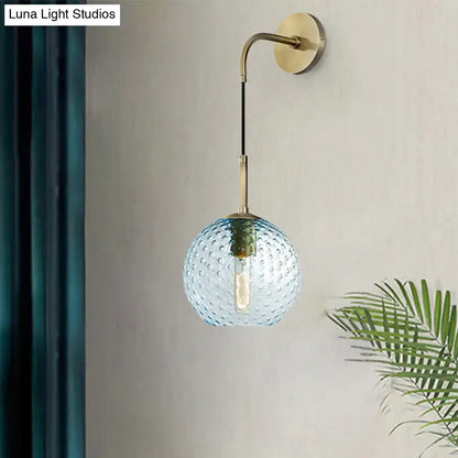 Retro blue glass globe wall lamp with textured bubble surface and brass hardware for pink yellow blue lighting