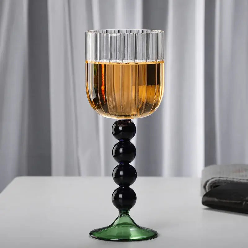 A tall elegant retro blue and green ribbed wine glass twister with black bead stem and glass twister stem design