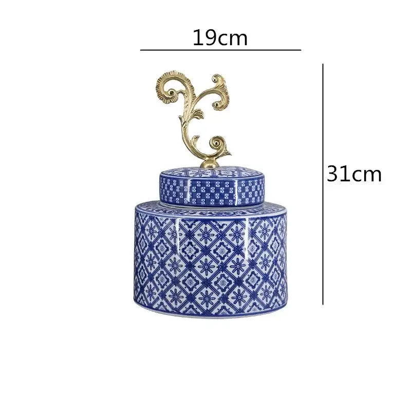 A blue and white porcelain covered vase jar with gold-toned ornate lid featuring intricate geometric patterns for living room storage