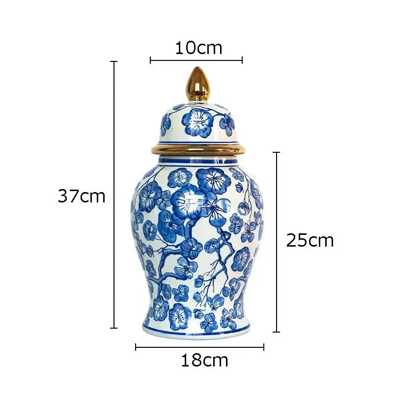 A tall elegant porcelain ginger jar with white base blue floral patterns and gold tipped lid for decorbites blue collection