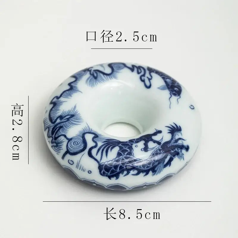 White ceramic donut-shaped incense burner with blue dragon motifs and glossy glaze from retro blue and white porcelain teacup tray set