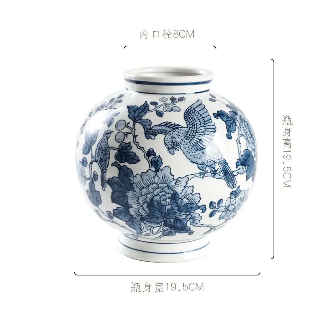 A round white porcelain vase with intricate blue hand-painted birds and flowers for living room decorbites blue white porcelain