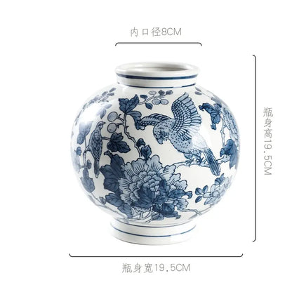 A round white porcelain vase with intricate blue hand-painted birds and flowers for living room decorbites blue white porcelain