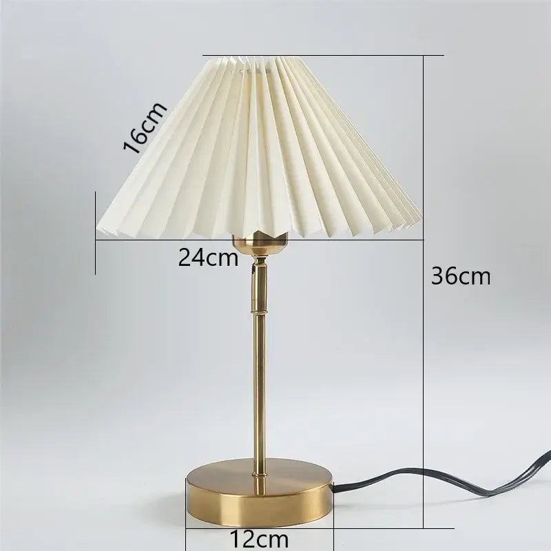 A cream adjustable pleated table lamp with a brass finish and dimensions marked for height and width