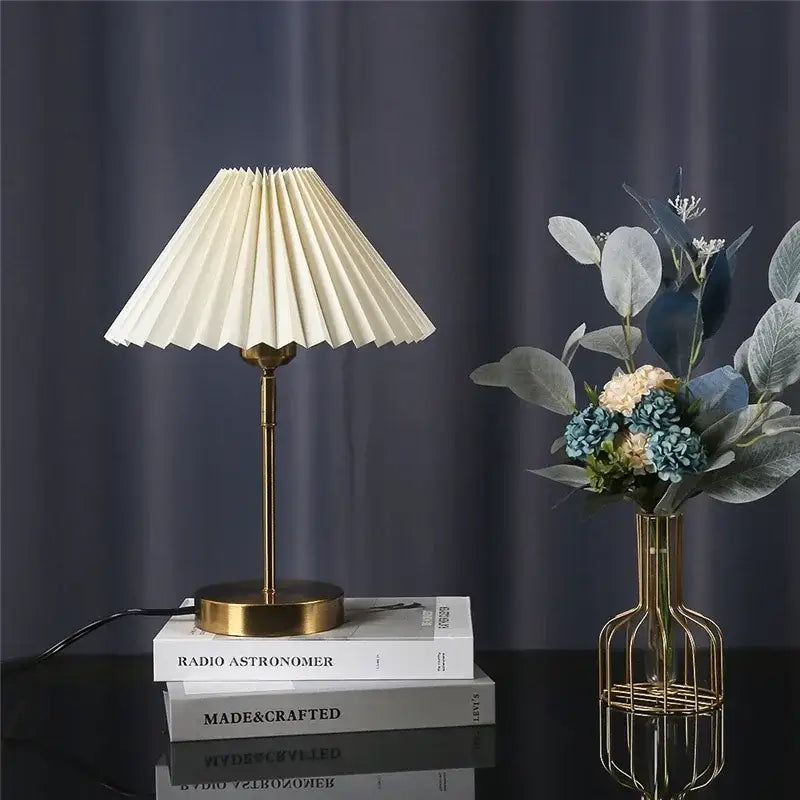 Cream-colored pleated table lamp with brass base and stem decorbites adjustable pleated bedroom light
