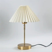 Cream-colored pleated lampshade on a slender brass finish adjustable pleated table lamp for bedroom decorbites lighting