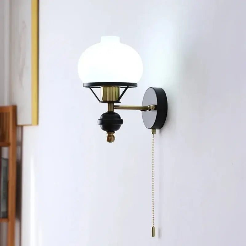 Retro brass and black french wall lamp with frosted glass globe shade vintage style wall lamp decorbites french wall
