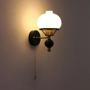 Warm-toned globe glass wall lamp with brass and black metal frame perfect for decorbites french wall lamp settings