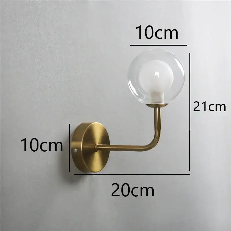 Brass-finished retro wall lamp with a clear glass ball bulb, ideal for bedroom decorbites glass ball lighting