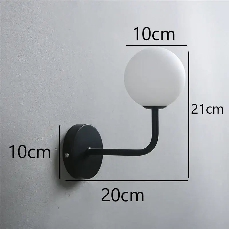 Black metal wall lamp with frosted white glass ball shade inspired by decorbites glass ball design for stylish lighting