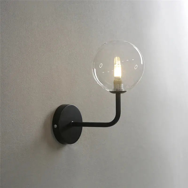 Black metal wall lamp with clear glass ball and illuminated filament bulb, perfect decorbites glass ball bedroom lighting