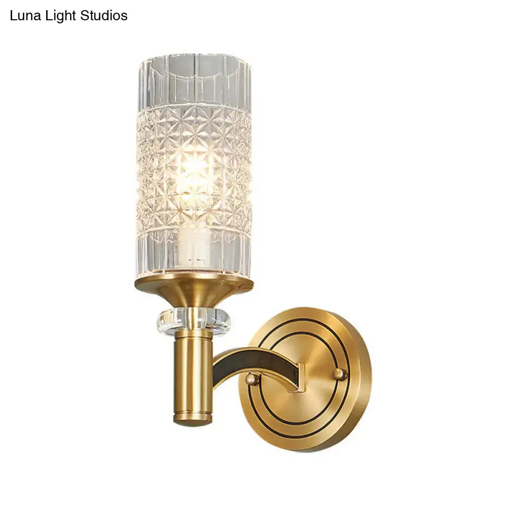 Retro brass gridded crystal wall light with brass base and cut glass cylinder for warm living room illumination
