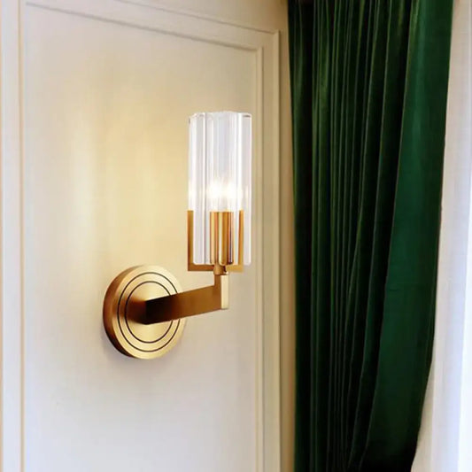 Retro brass ribbed glass wall lamp with gold-toned finish and clear vertically ribbed shade measuring inches wide for living room use
