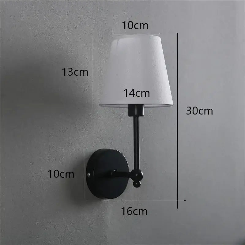 Black metal wall lamp with white fabric lampshade featuring a gold led retro style for bedroom use