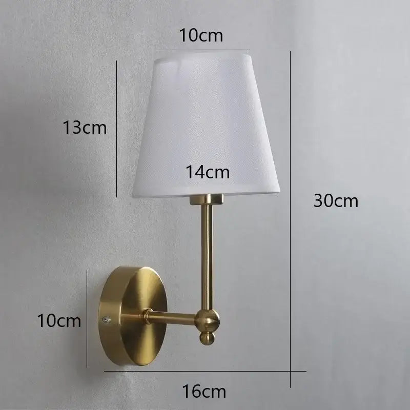 Brass-finished wall lamp with a white tapered fabric shade ideal for gold led retro bedroom sconce lighting