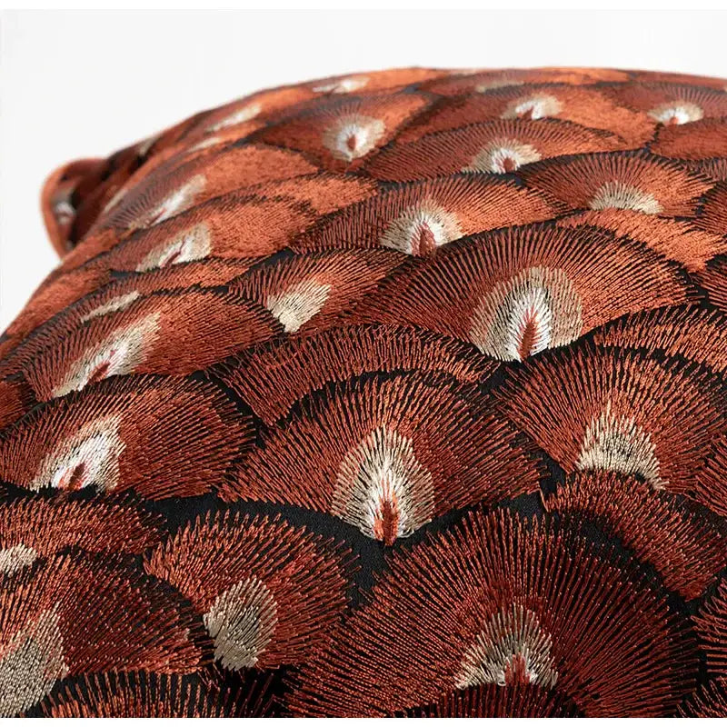 A retro brick red embroidered geometry pillow featuring fan-shaped motifs in deep rust and metallic silver threadwork