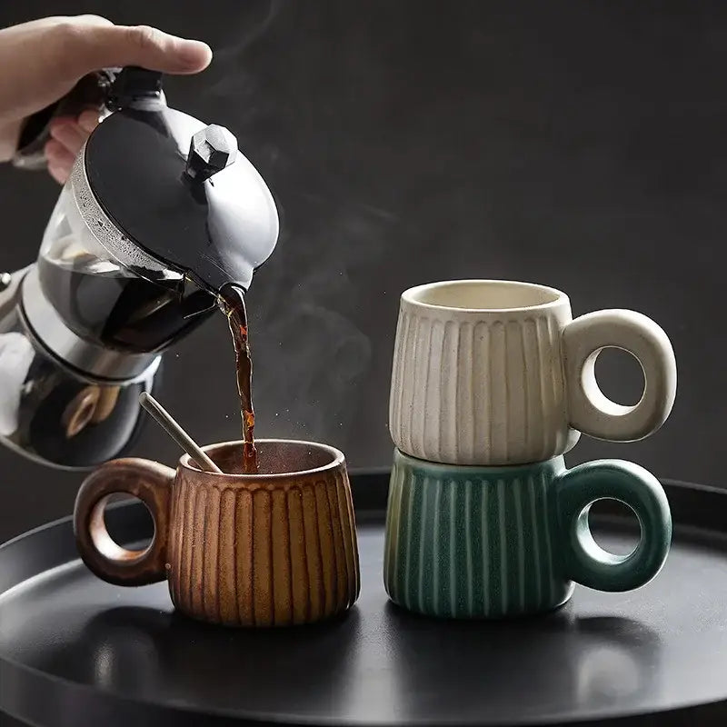 Set of three handmade nordic ceramic mugs with vertical ribs in brown, off-white, and teal for kitchen coffee use