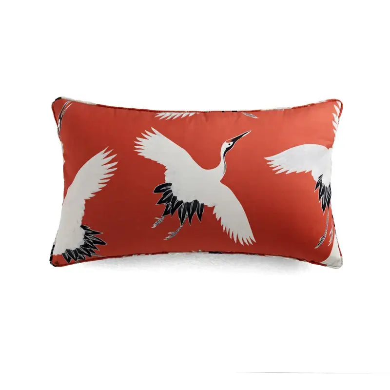 Rectangular pillow cover with vibrant orange decorbites circus retro design featuring white cranes and black feather details