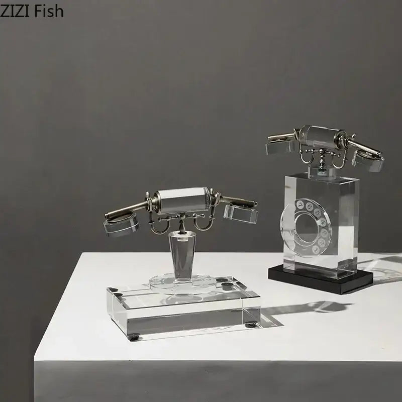 Two clear crystal telephone sculptures with vintage handsets and metallic accents on acrylic desk bases for office decor