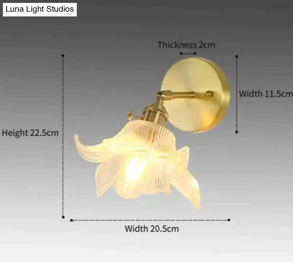 Gold-toned retro copper flower brass wall sconce with a translucent frosted glass flower-shaped shade for bedroom use