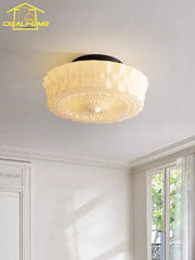 Cream decorbites glass led ceiling light with black base and textured radial pattern for bedroom decor