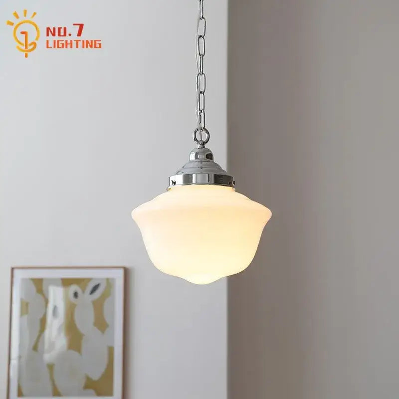 Warm softly glowing decorbites cream glass pendant light with frosted glass shade and polished chrome hardware