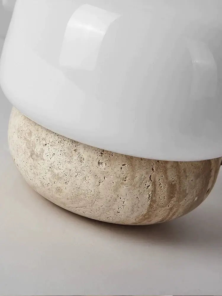 A cream mushroom table lamp with a sleek white ceramic lampshade and textured beige stone base for decorbites