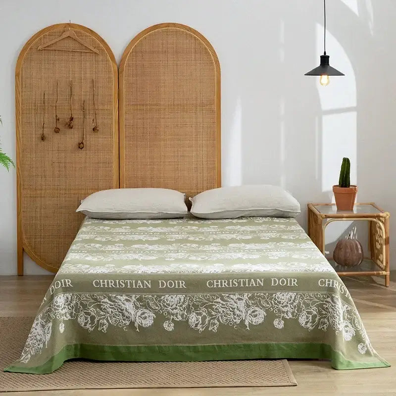 Olive green and white floral patterned cotton throw blanket with christian doir branding from decorbites cotton throw collection