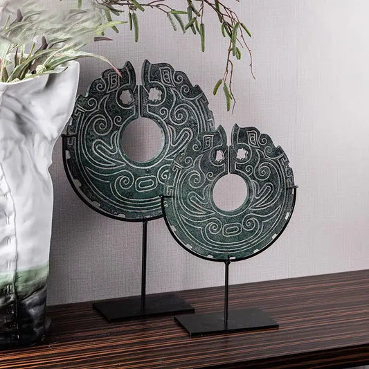 Two dark green jade disc totem resin statues with intricate carvings on black stands for decorbites geometric totem decor