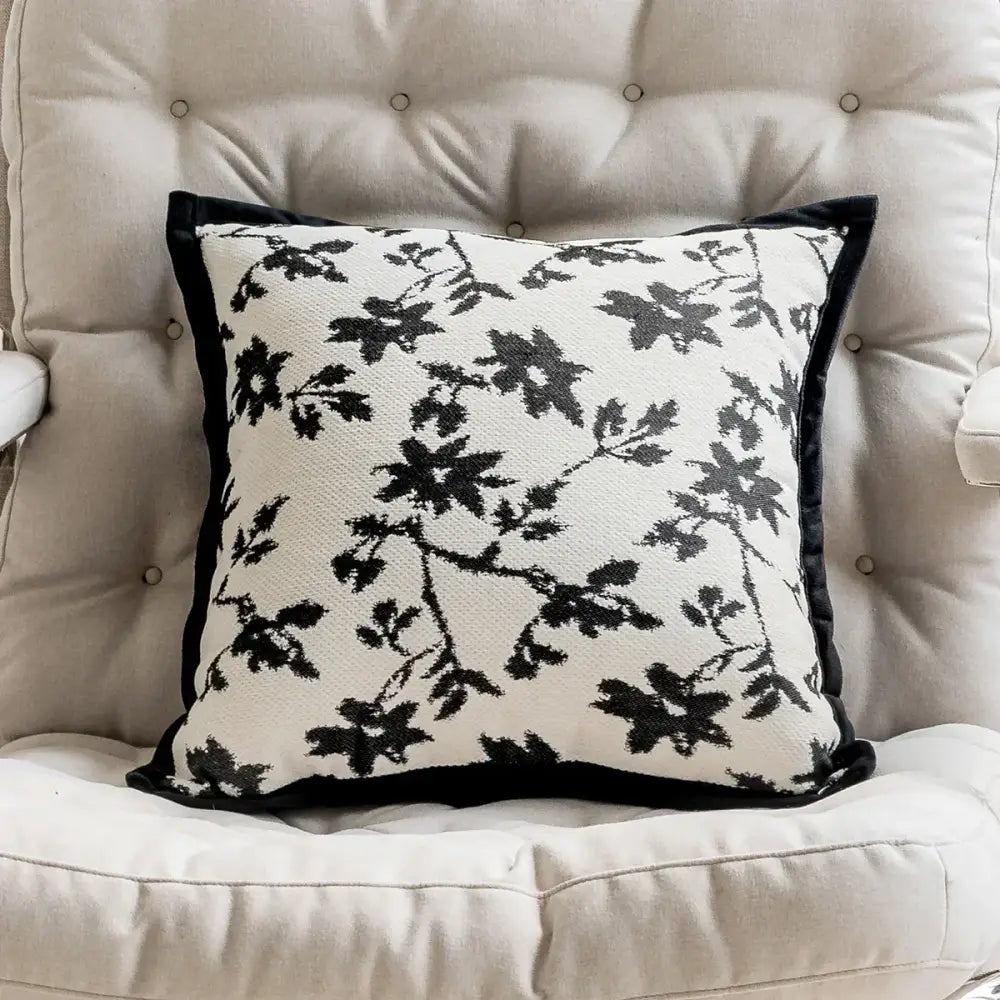 Black and white floral patterned pillow cover with velvet trim featuring embroidered jacquard luxury design