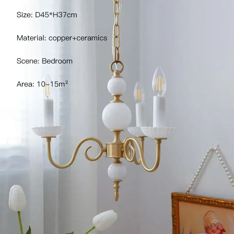 Gold-toned copper decorbites cream white led chandelier with white ceramic orbs and candle-style bulbs for dining room use