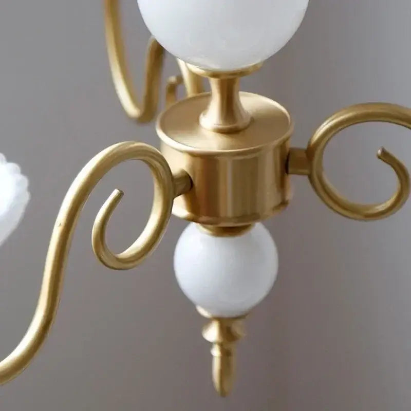 Gold-toned decorbites cream white led chandelier with elegant curved arms and white spherical glass shades for dining room
