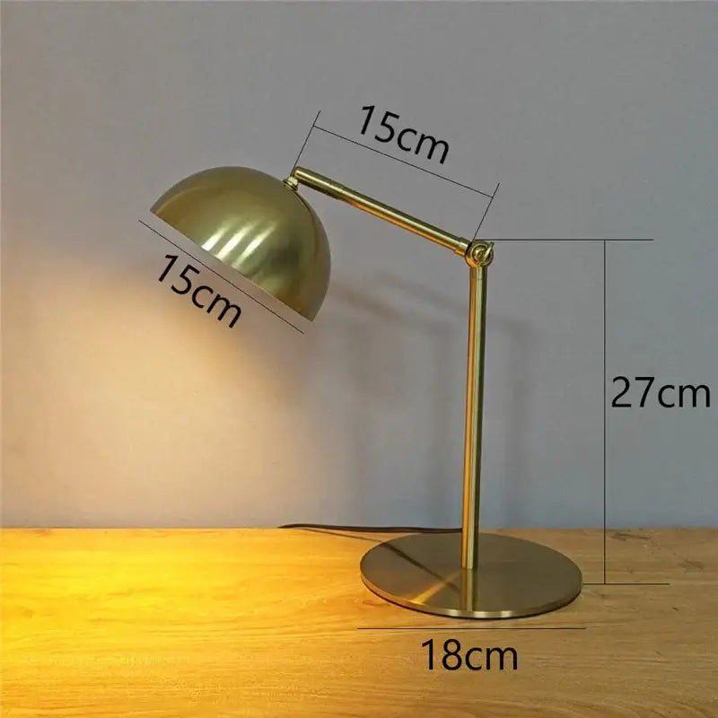 A sleek brass retro gold adjustable angle floor lamp with dome shade and adjustable arm for bedroom reading light