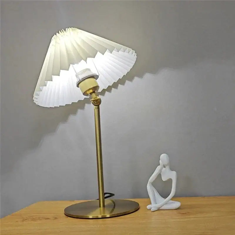 A white pleated paper lampshade floor lamp with brass metal base and decorbites adjustable angle for reading light