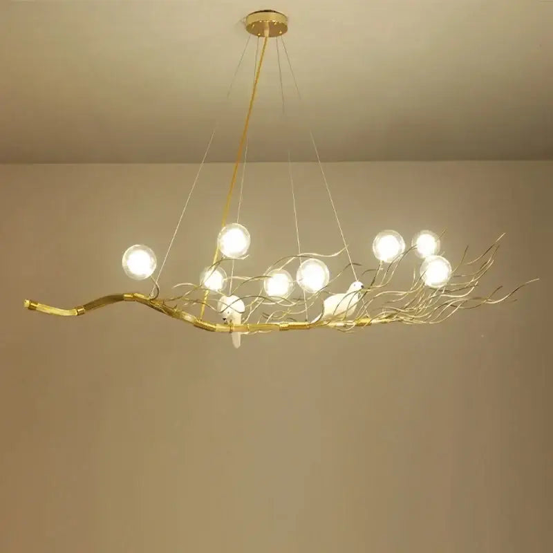 Retro gold bird nest led chandelier with gold-toned branch design, glass globe bulbs, and white bird figurines for dining room decorbites bird nest