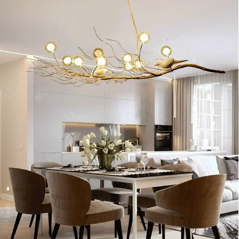 Retro gold bird nest led chandelier featuring a golden branch design with spherical glass globe lights and bird figurine