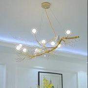 Retro gold bird nest led chandelier with gold-toned branches, clear glass globe lights, and white ceramic birds decorbites bird nest