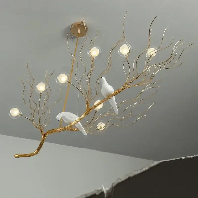 Retro gold bird nest led chandelier with gold-toned branch design, white ceramic doves, and glowing glass globe bulbs for dining room decorbites bird nest