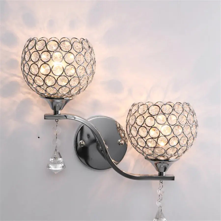 Chrome finished crystal wall sconce with two spherical shades and teardrop crystals for decorbites crystal wall decor